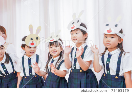 Children and nursery teachers practicing the recital 75465179