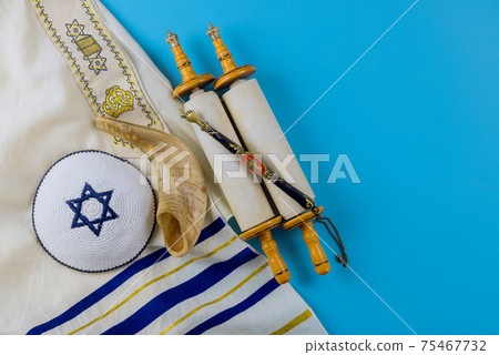 Jewish holidays, during prayer items kippa with prayer shawl tallit on shofar, torah scroll 75467732