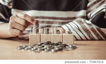 Woman's hands put the coins arranged in steps, Managing your finances or saving money for future use, Saving for investment, Saving money for business growth or long-term profitability. 75467818