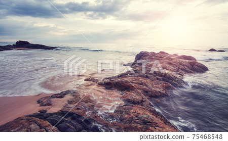 Scenic sunset on a rocky beach, color toning applied, Sri Lanka. 75468548
