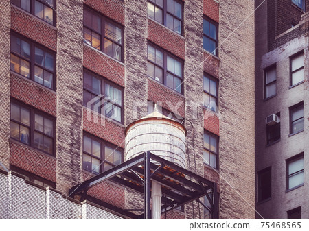 Water tower on a roof of an old building in Manhattan, color toning applied, New York City, USA. 75468565