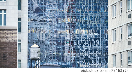 Old water tower, one of New York City symbols, among modern buildings, USA. Old water tower, one of New York City symbols, among modern buildings, USA. 75468574