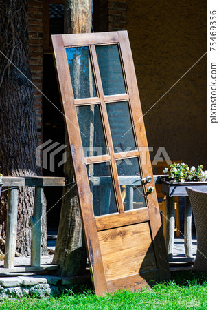 Old door in a garden Old door in a garden 75469356