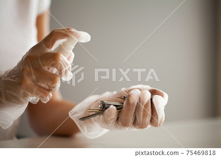 Woman disinfecting keys with disinfectant on the table Woman disinfecting keys with disinfectant on the table 75469818