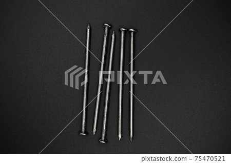 Pile of construction iron pointed nails, isolated on balck background Pile of construction iron pointed nails, isolated on balck background 75470521