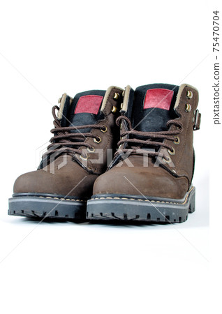Hiking shoes and a white background, Sturdy hiking boots Hiking shoes and a white background, Sturdy hiking boots 75470704