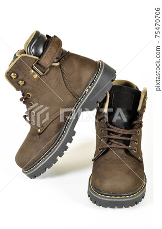Hiking shoes and a white background, Sturdy hiking boots Hiking shoes and a white background, Sturdy hiking boots 75470706