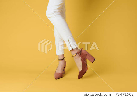 Female feet fashionable shoes luxury yellow background elegant style 75471502
