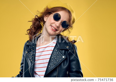 Girl in a yellow hat dark glasses fashionable clothes studio lifestyle childhood 75471736