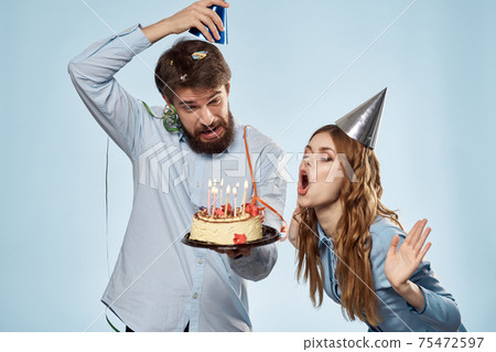 Emotional man with cake and pretty woman party disco blue background 75472597