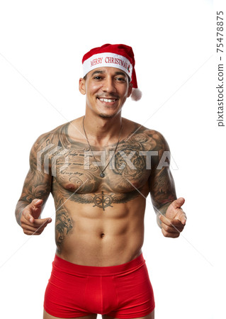 Portrait of athletic smiling tattooed guy. Studio shot, isolated Portrait of athletic smiling tattooed guy. Studio shot, isolated 75478875