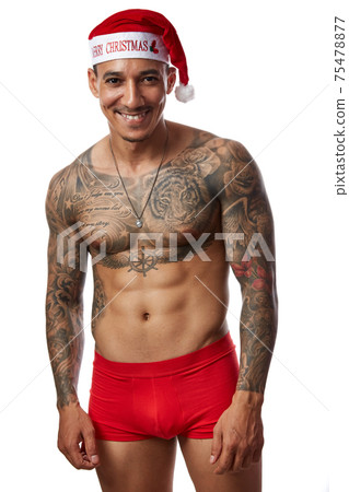 Portrait of athletic smiling tattooed guy. Studio shot, isolated Portrait of athletic smiling tattooed guy. Studio shot, isolated 75478877