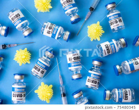 Glass vials for Covid-19 vaccine on blue background. Group of Coronavirus vaccine bottles. 75480345