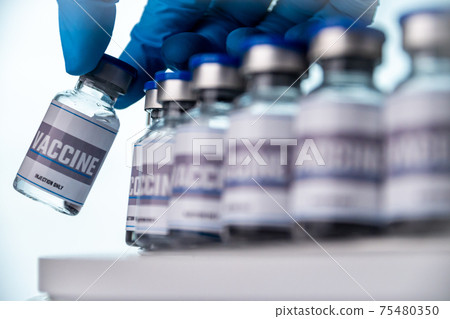 Glass vials for vaccine in laboratory. Group of vaccine bottles. Medicine in ampoules. 75480350