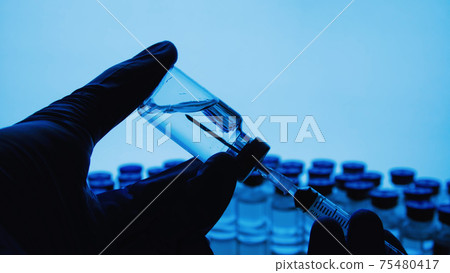 Vaccine bottles and syringe injection. Medicine in ampoules. Glass vials for liquid samples in laboratory. 75480417