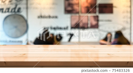 Empty wooden table top with lights bokeh on blur restaurant background. Empty wooden table top with lights bokeh on blur restaurant background. 75483326