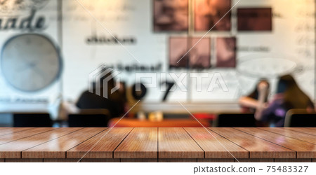 Empty wooden table top with lights bokeh on blur restaurant background. Empty wooden table top with lights bokeh on blur restaurant background. 75483327