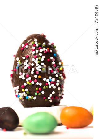 Chocolate Easter eggs with egg candies on white background 75484695