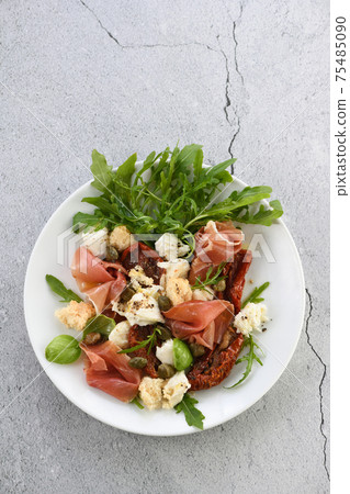 Parma ham with mozzarella and sun-dried tomatoes Parma ham with mozzarella and sun-dried tomatoes 75485090