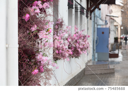 City street is decorated with artificial flowers. City street is decorated with artificial flowers. 75485688