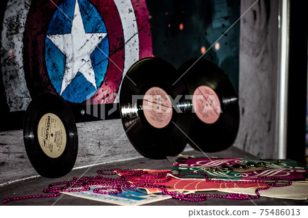 Retro Vinyl records music background near the superhero wall audio disc 75486013