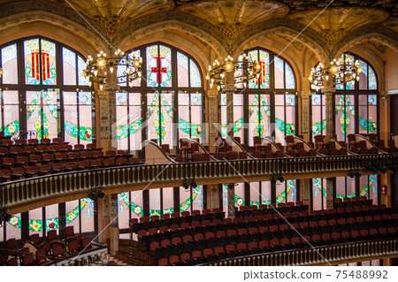 Palau de la Musica Catalana in Barcelona, Spain, seats for spectators surrounded by stained glass windows and carved ceilings 75488992