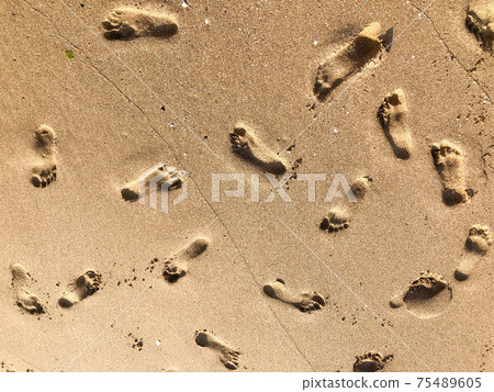background with footprints on the sandy beach in summer background with footprints on the sandy beach in summer 75489605