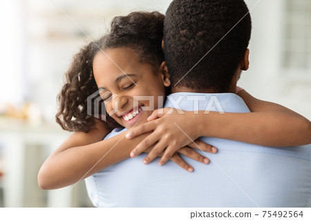 Happy black girl hugging her dad, closeup Happy black girl hugging her dad, closeup 75492564