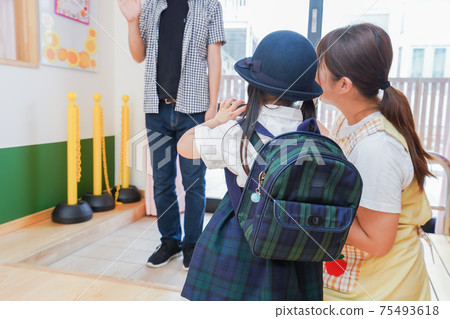 Parents picking up and dropping off at the nursery school 75493618