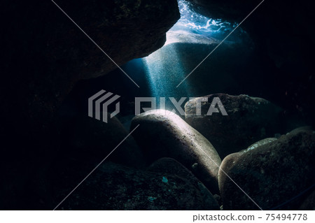 Underwater cave in ocean with sun rays 75494778