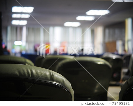 blur lonesome abandoned almost empty passenger's waiting room in front of gate in a previous tourist destination airport in COVID-19 pandemic era  75495181