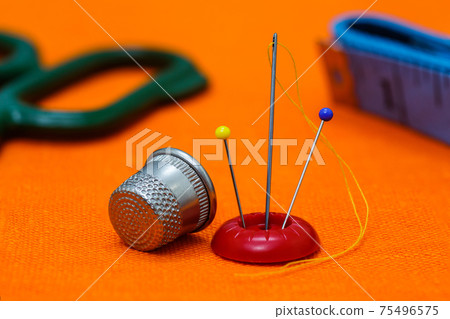 needle with yellow thread needle with yellow thread 75496575