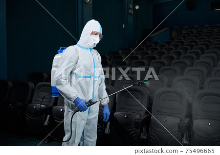 Worker disinfect cinema hall against coronavirus. 75496665