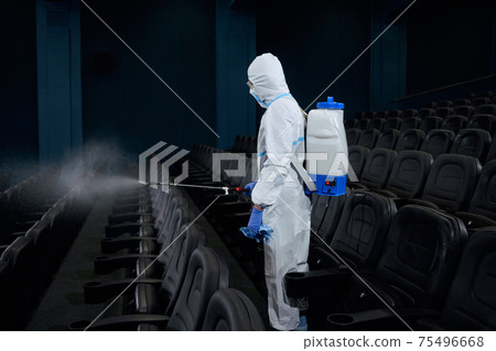 Special person making disinfection in cinema hall. Special person making disinfection in cinema hall. 75496668