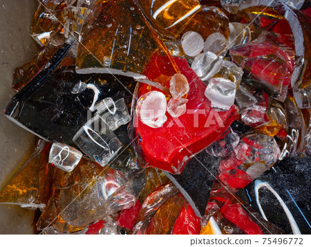 Stained glass shards and waste in a glass studio container Stained glass shards and waste in a glass studio container 75496772