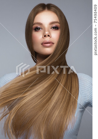 Beautiful blond girl with a perfectly smooth hair, and classic make-up. Beauty face and hair. Beautiful blond girl with a perfectly smooth hair, and classic make-up. Beauty face and hair. 75498409
