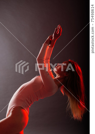 Woman in colorful neon light. Stylish hair, trendy bodysuit, makeup. Creative art beauty concept Woman in colorful neon light. Stylish hair, trendy bodysuit, makeup. Creative art beauty concept 75498614