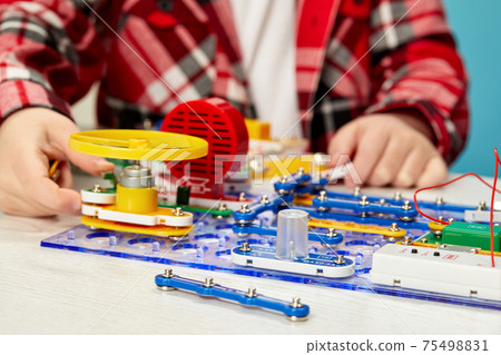 children playing with electronic constructor at studio 75498831
