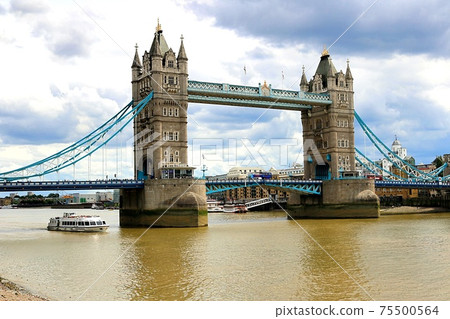 London's Tower Bridge and River Thames in a typical cloudy sky in England 75500564