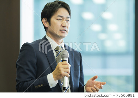 A businessman talking with a microphone A businessman talking with a microphone 75500991