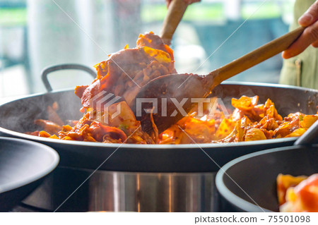 Tokboki (Korean tranditional food hot and spicy rice cake), combination and apply puff with cheese and vegetable on the black table 75501098