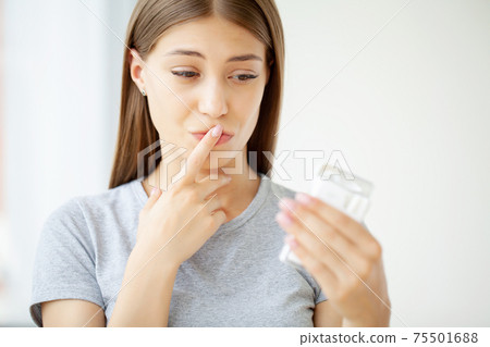 A healthy young woman refuses to take a cigarette from a pack. 75501688