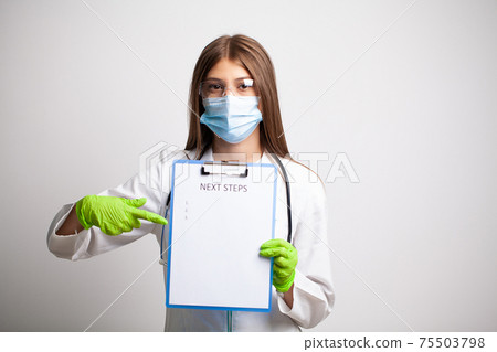 Doctor in a white coat holds a letter with text next steps 75503798