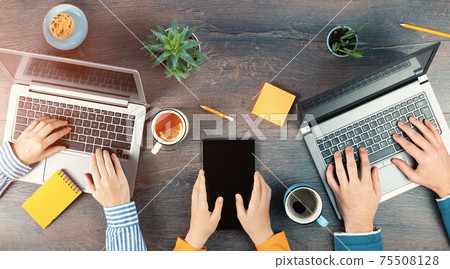Three unrecognizable people laptop for remote working or studying top view Three unrecognizable people laptop for remote working or studying top view 75508128