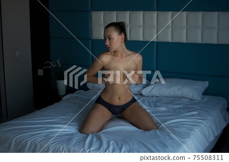 Topless voluptuous woman in bedroom Topless voluptuous woman in bedroom 75508311