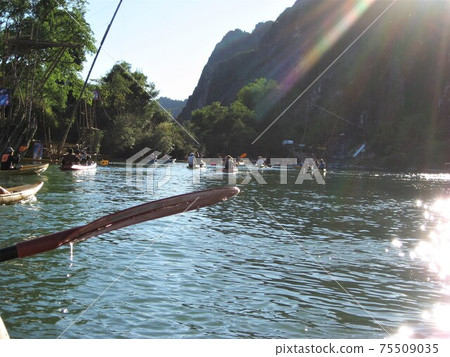 Kayaking on a trekking tour in Vang Vieng, Laos. Kayaking on a trekking tour in Vang Vieng, Laos. 75509035