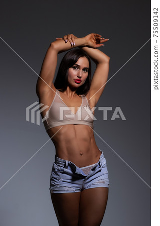 Voluptuous woman in underwear standing gracefully in studio Voluptuous woman in underwear standing gracefully in studio 75509142