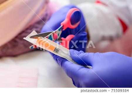 Milium on the face, removal of milia with a syringe in cosmetology. 75509384