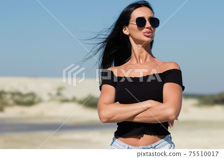 Gorgeous female in bikini relaxing on beach 75510017