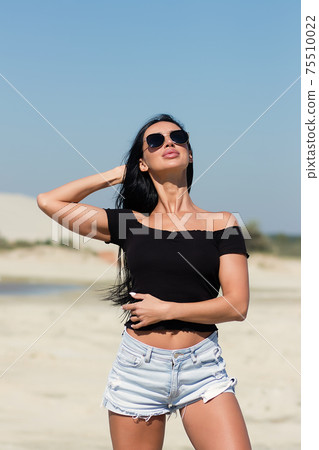 Gorgeous female in bikini relaxing on beach Gorgeous female in bikini relaxing on beach 75510022